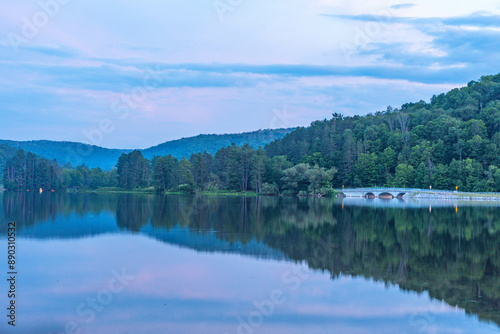 Setting sun low light long exposure over mountain lake summer season background image