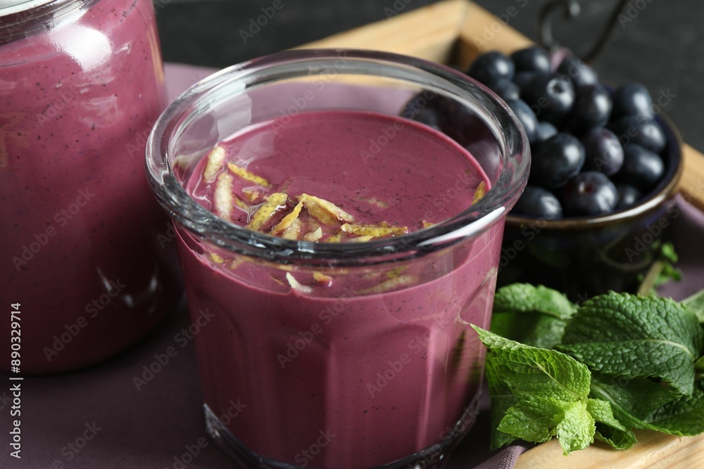 Tasty fresh acai juice with lemon zest, mint and berries on grey table, closeup Tasty fresh acai juice with lemon zest, mint and berries on grey table, closeup