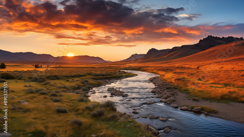 Majestic Sunset Behind Mountains with River Flowing in the Foreground