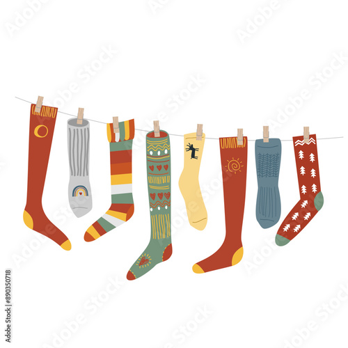 Warm and Cozy Christmas socks pinned on a rope. Isolated gift boot, New Year home decorative element in eco style, vector illustration.