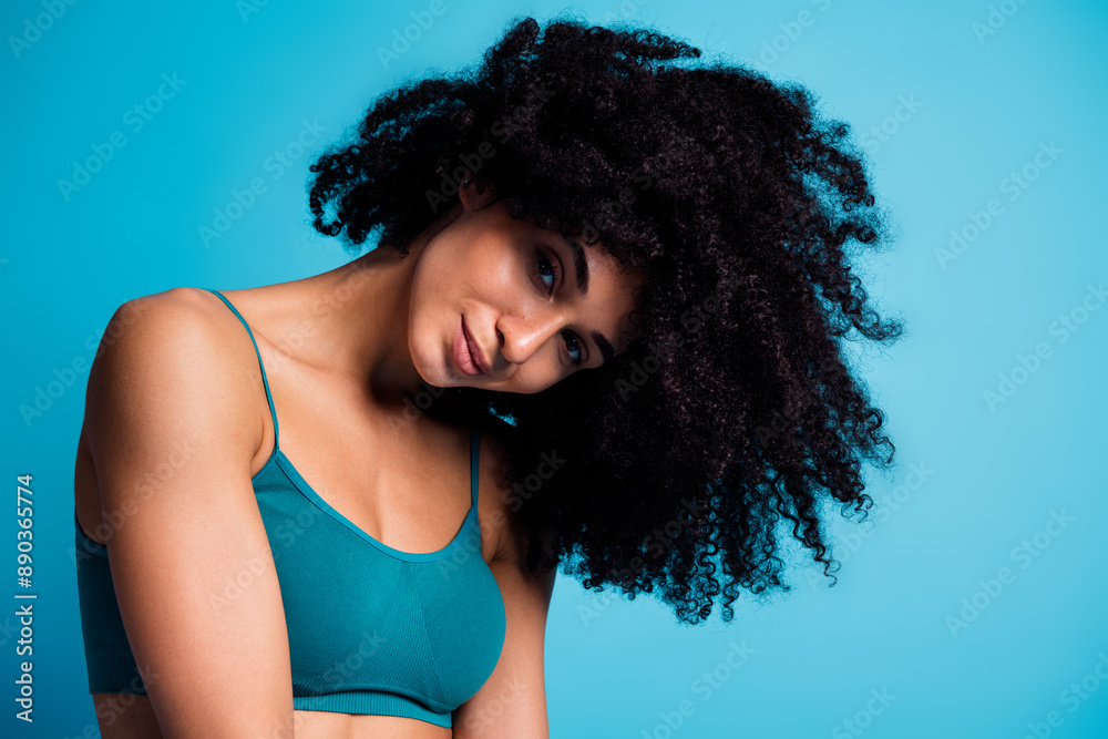 Photo of attractive girl look with thick curly wavy hair isolated blue color background Photo of attractive girl look with thick curly wavy hair isolated blue color background