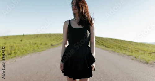 Attractive caucasian woman on roller skates on road way in sunny day. Portrait of sporty girl