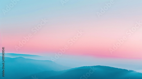 This is a beautiful landscape image of a mountain range at sunset. The sky and mountains are a gradient of pink, blue, and purple. © Creative
