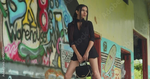 A young Latina in red heels at an indoor skate park warehouse