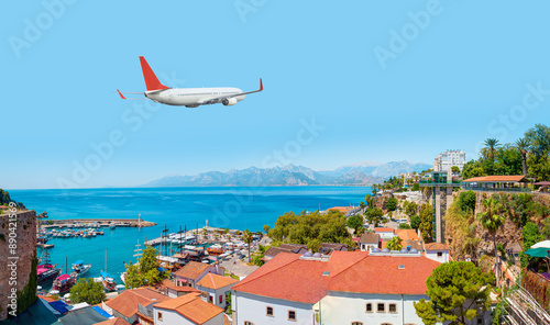 Fototapeta Naklejka Na Ścianę i Meble -  White an air plane fly over the Old Town Kaleici - Antalya, Turkey