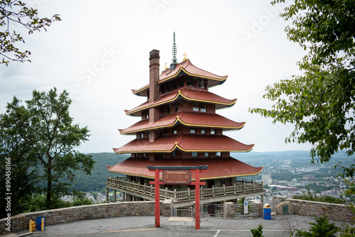 Overview of an Asian Pagoda looking over a forest and city.