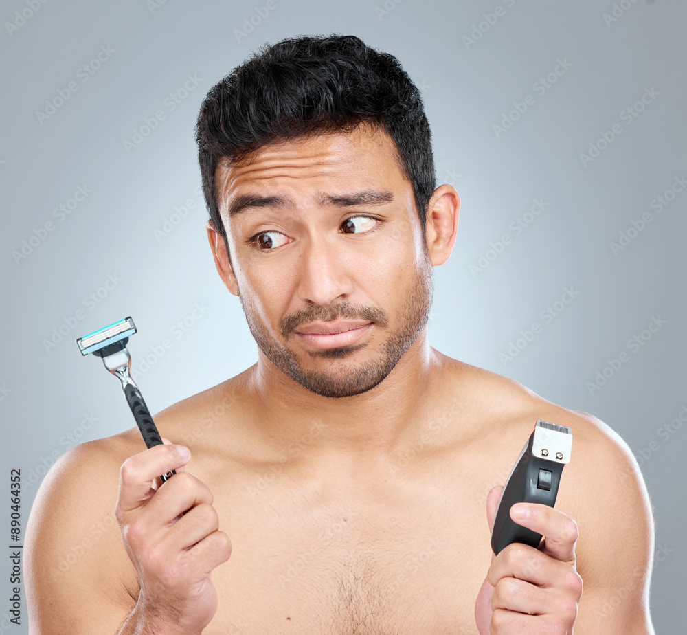 Man, razor and choice for skincare, grooming or facial treatment on a gray studio background. Hygiene, decision and product for thinking, trimming and confused for morning beard routine with doubt