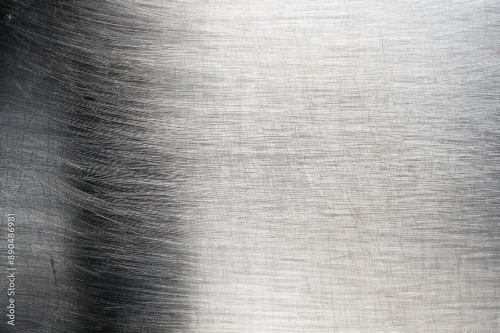 Close-up texture of brushed stainless steel surface with horizontal and vertical scratches, suitable for backgrounds and industrial design projects. Close-up texture of brushed stainless steel surface with horizontal and vertical scratches, suitable for backgrounds and industrial design projects.