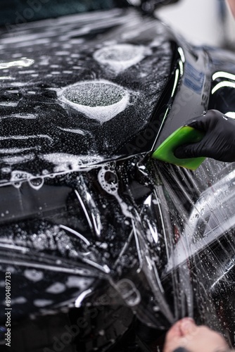 Obraz na płótnie Detailing car wheel using brush for thorough cleaning. Focus on precision and high-quality finish in professional auto detailing, ensuring spotless and shiny wheels w salonie