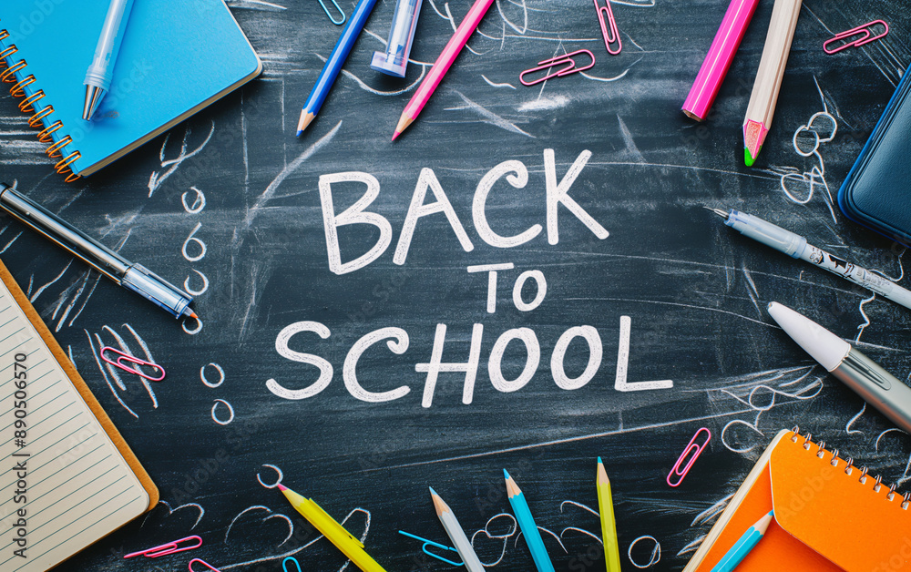 Back to school concept featuring a chalkboard with the words back to school written on it, surrounded by school supplies Back to school concept featuring a chalkboard with the words back to school written on it, surrounded by school supplies