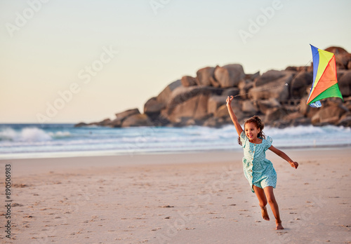 Girl child, kite and running at sea vacation and holiday with smile, fun and outdoor summer travel. Growth, flying and fast female kid alone at beach for adventure trip, wellness and playing in ocean