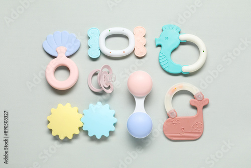 Different baby rattles on light background, flat lay