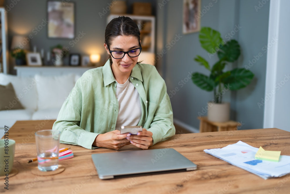 Young business woman using break from working in home office for surfing on social media. Female freelance designer professional using smartphone for text messaging communication. Young business woman using break from working in home office for surfing on social media. Female freelance designer professional using smartphone for text messaging communication.