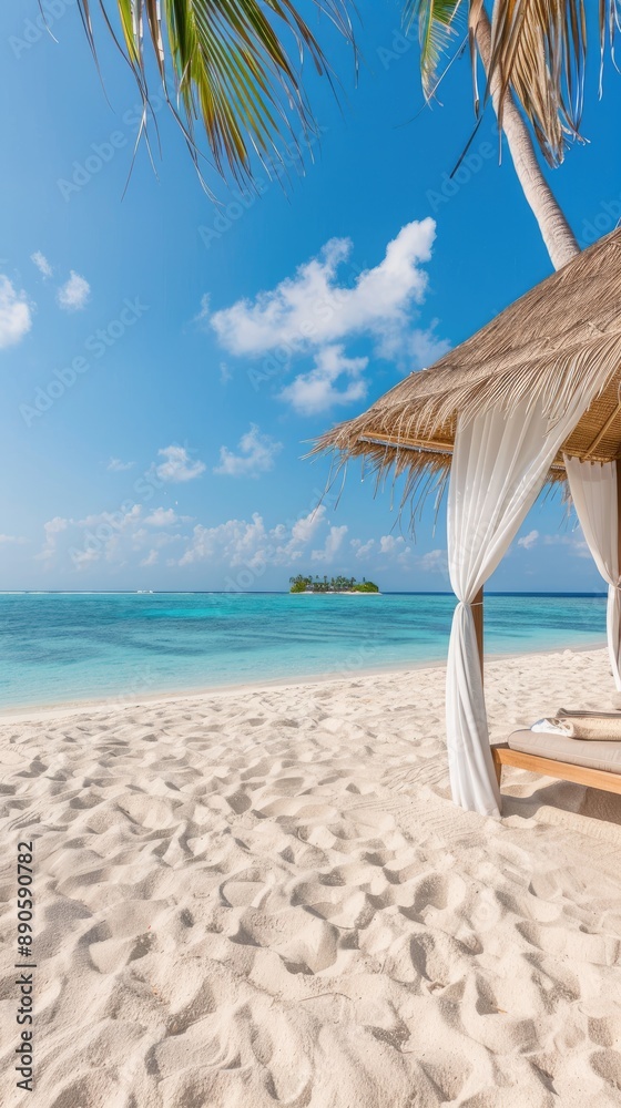 A white canopy bed sits on a white sand beach. Behind it is a turquoise ocean with a palm tree on the left and another one on the right A white canopy bed sits on a white sand beach. Behind it is a turquoise ocean with a palm tree on the left and another one on the right