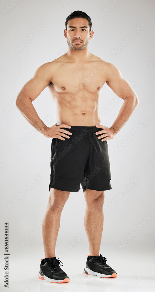 Fototapeta premium Fitness, portrait or man topless in studio with abs, muscle development or confident for progress. Male athlete, arm strength or serious on gray background for goal, healthy body or personal trainer