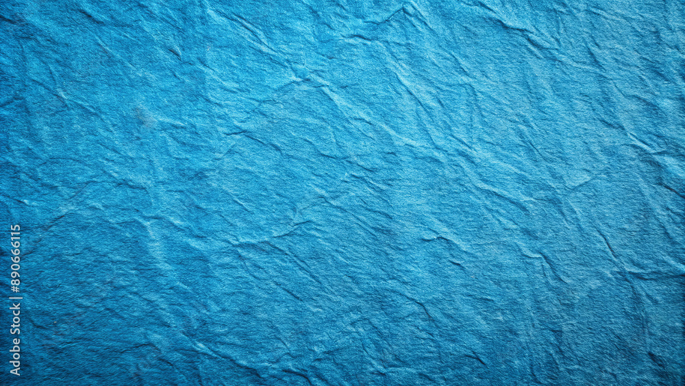 A close-up image of a crumpled blue paper surface A close-up image of a crumpled blue paper surface