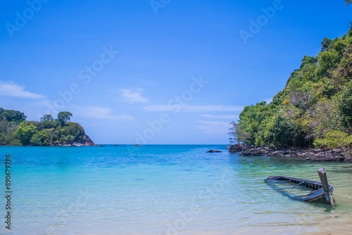 Beautiful sandy beach with long tail boats anchored on the beach of Koh Kamtok, Ranong Province, Thailand, Asia