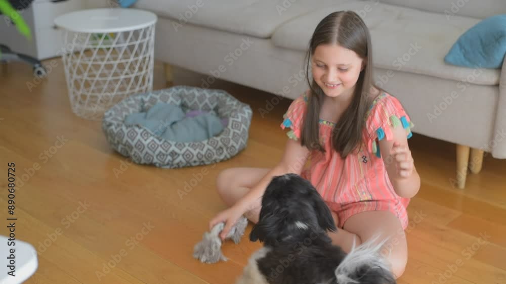 Kid girl play with dog. Family having fun at home with dog
