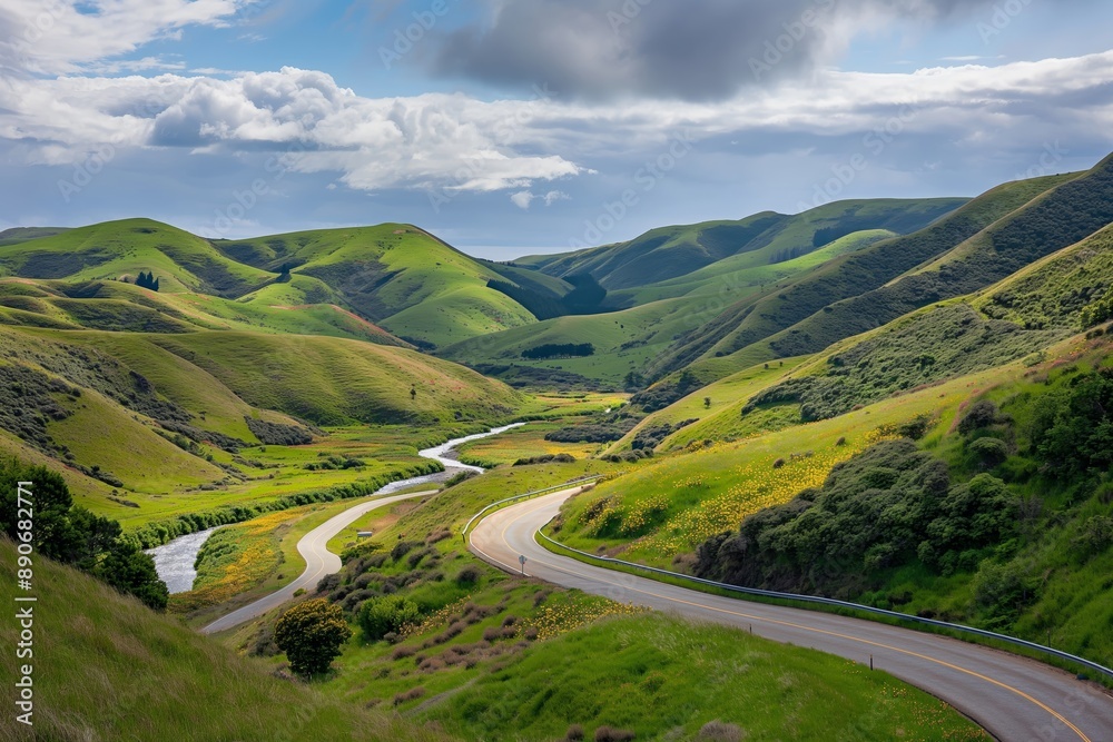 A winding road runs through a lush green valley. Road to somewhere concept A winding road runs through a lush green valley. Road to somewhere concept