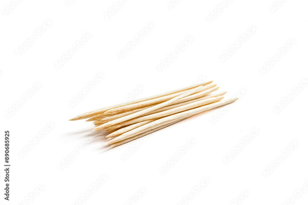Close-up of wooden toothpicks on a white background Close-up of wooden toothpicks on a white background
