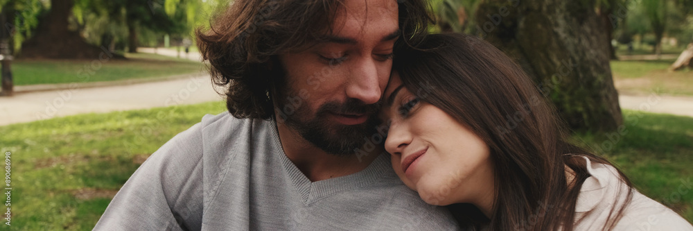 Close up, love couple hugging on lawn Close up, love couple hugging on lawn