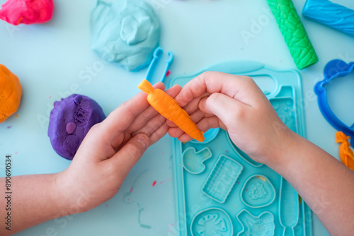 Colorful clay. Child's hands playing with colorful clay. Plasticine. play dough.