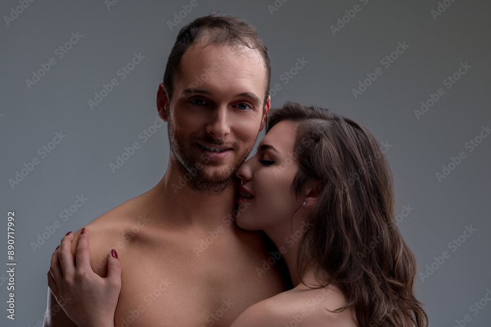 Woman embraces, man smiles, feeling deeply desired Woman embraces, man smiles, feeling deeply desired