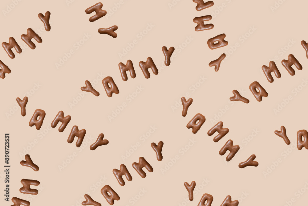 Sweet composition with the word Yammy on a beige background. Alphabet biscuits on a pastel background, top view Sweet composition with the word Yammy on a beige background. Alphabet biscuits on a pastel background, top view