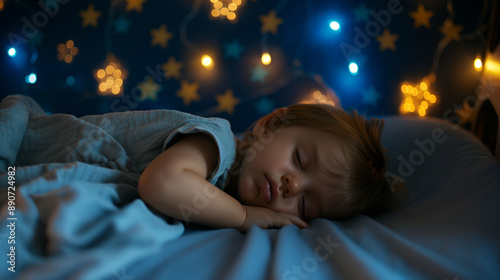 Side view of a beautiful and cute male toddler baby kid sleeping and resting at night in a dark room with blue and yellow glowing stars on the walls. Little newborn child sweet dreams, infant bedroom
