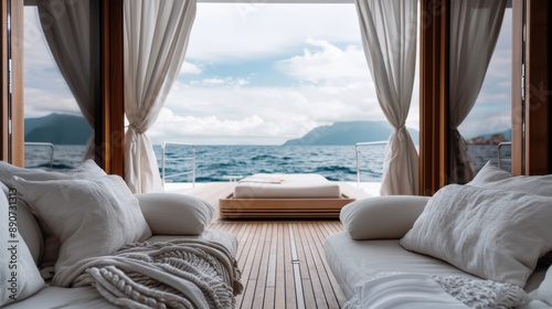 This image depicts a luxurious yacht deck with cushioned seating and a scenic view of the ocean and distant mountains, highlighting comfort and opulence at sea.