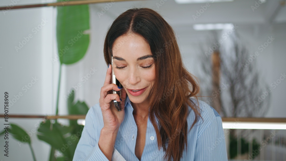 Attractive brunette talking mobile phone closeup. Smiling woman raising eyes Attractive brunette talking mobile phone closeup. Smiling woman raising eyes
