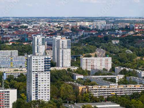 Ultra telephoto shot over Halle Neustadt towards the city center of Halle Saale. In the foreground are three high-rise buildings on the edge. The district is celebrating its 60th anniversary.