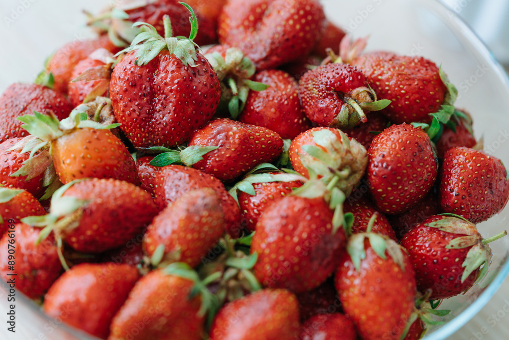 Pile of fresh, ripe strawberries with vibrant red color and green stems, ready to eat. Pile of fresh, ripe strawberries with vibrant red color and green stems, ready to eat.