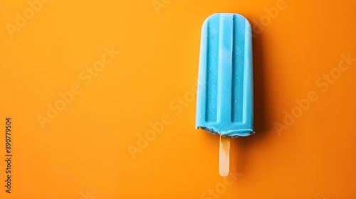 Blue Popsicle on a summery orange Background with Copy Space