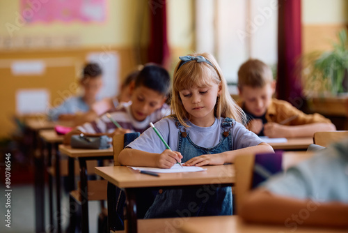 Elementary student learning during class at school.