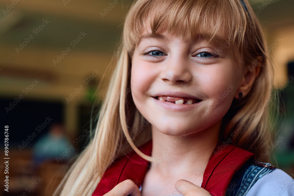 Close up of happy schoolgirl in classroom looking at camera. Close up of happy schoolgirl in classroom looking at camera.