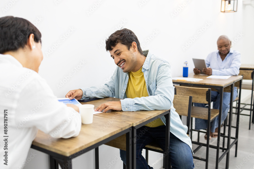 Adult students engaging in lively discussion at an English academy Adult students engaging in lively discussion at an English academy