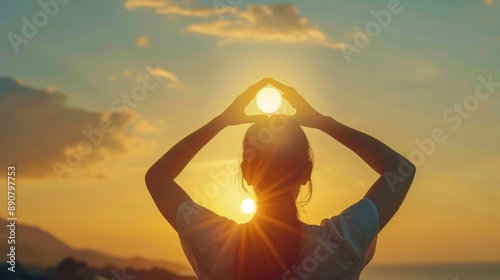 The woman making frame round the sun with her hands in sunrise,Future planning idea concept. photo