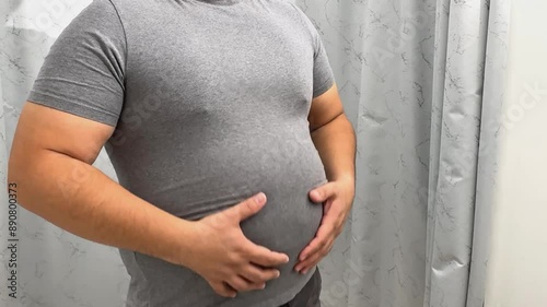 Unhealthy Overweight Man Pinches Fat Stomach,
person with stomach pain
