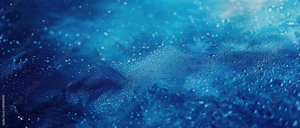 Obraz premium A mesmerizing abstract image of water droplets on a blueish background evoking a mystical underwater feel.