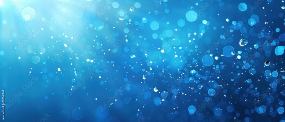 Abstract image of water drops floating in a blue, glowing light. The image exudes a calm and serene atmosphere. Abstract image of water drops floating in a blue, glowing light. The image exudes a calm and serene atmosphere.