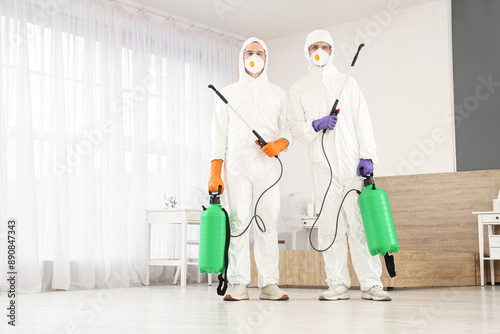 Male workers with disinfect...