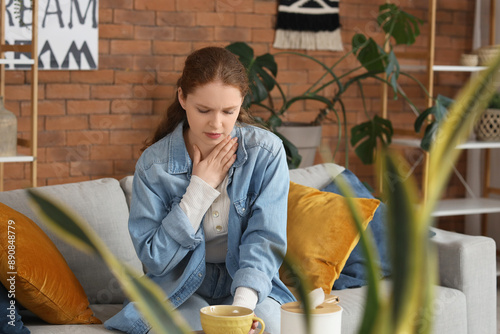 Sick young woman with sore ...