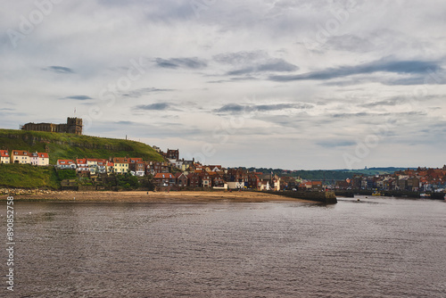 Scenic coastal town with historic buildings and sandy beach in Whitby, North Yorkshire