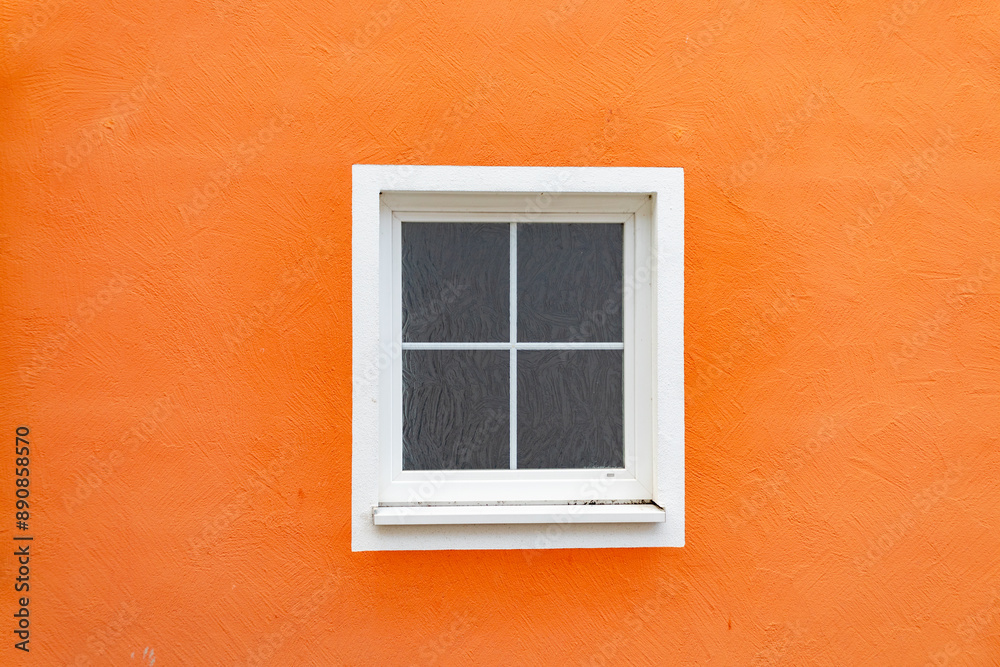 detail of orange wall with old white painted window detail of orange wall with old white painted window