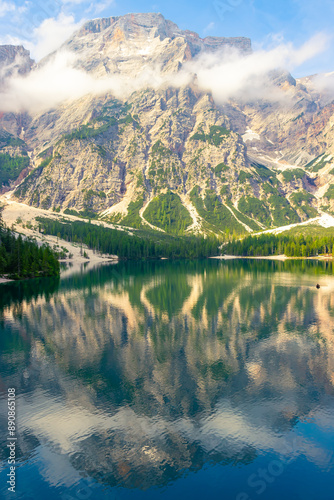 At Lake Braies in the morning on holiday in South Tyrol. A mountain in the Alps in the background
