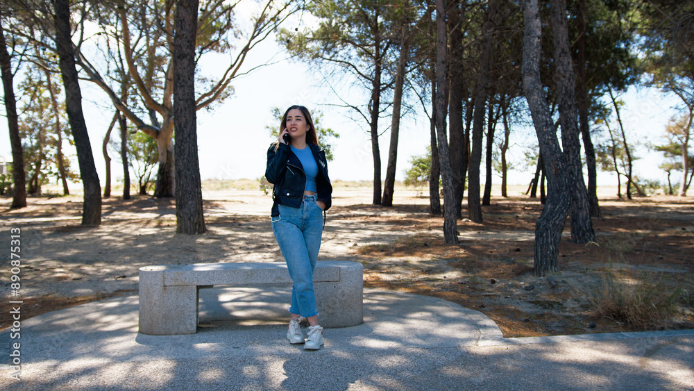 Fototapeta premium Woman Having A Call In The Park