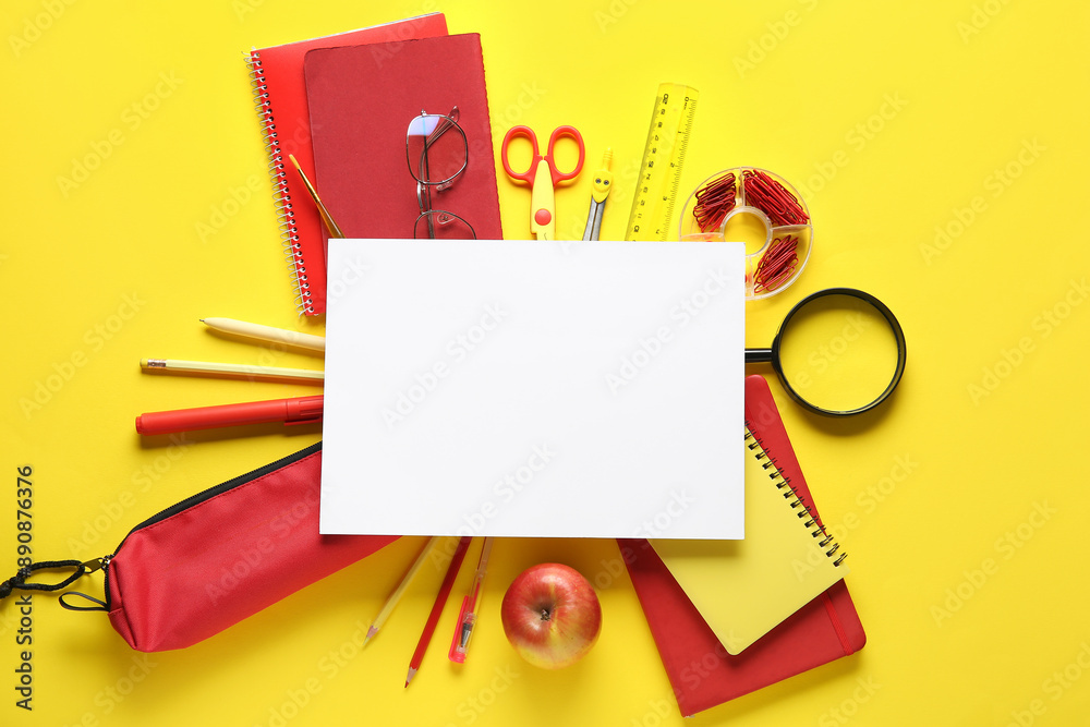 School supplies with paper sheet on yellow background. Top view School supplies with paper sheet on yellow background. Top view