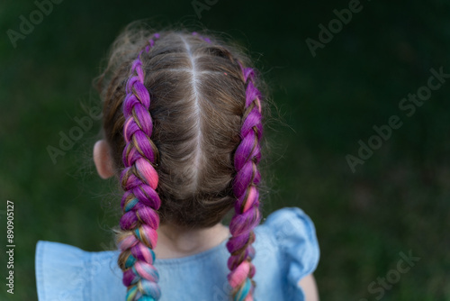 Fotografie Caucasian child from behind coloured braided hair extensions