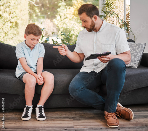 Angry, father and child with tablet for discipline scolding for behaviour, conflict lecture or tech punishment of lesson. Frustrated, man and boy with digital for internet mistake, tantrum and house